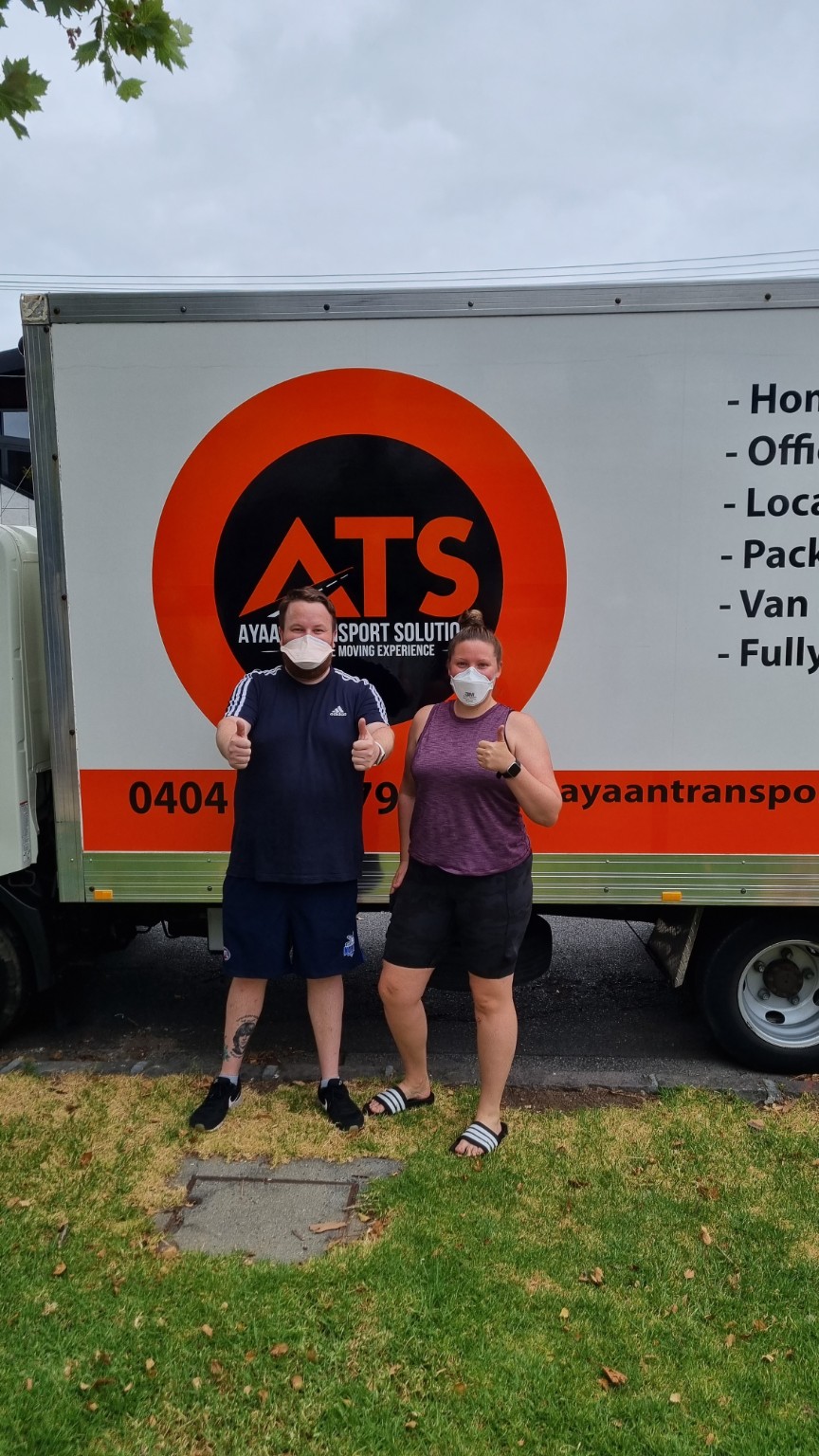 Happy customers beside the Ayaan Transport Solutions truck