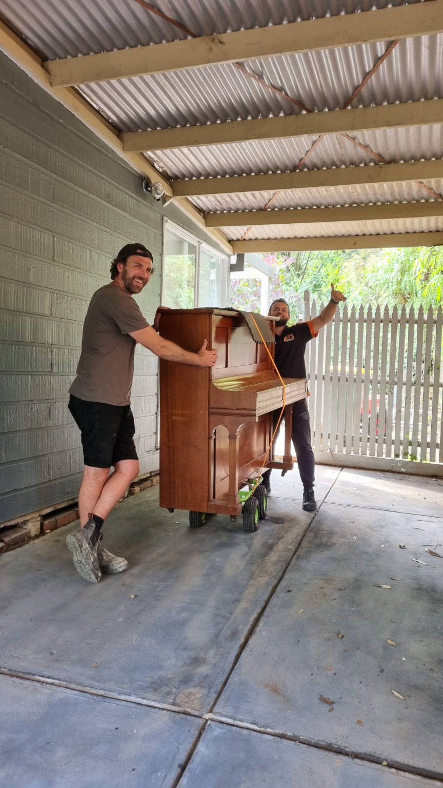 ATS mover carefully moving a piano with a customer